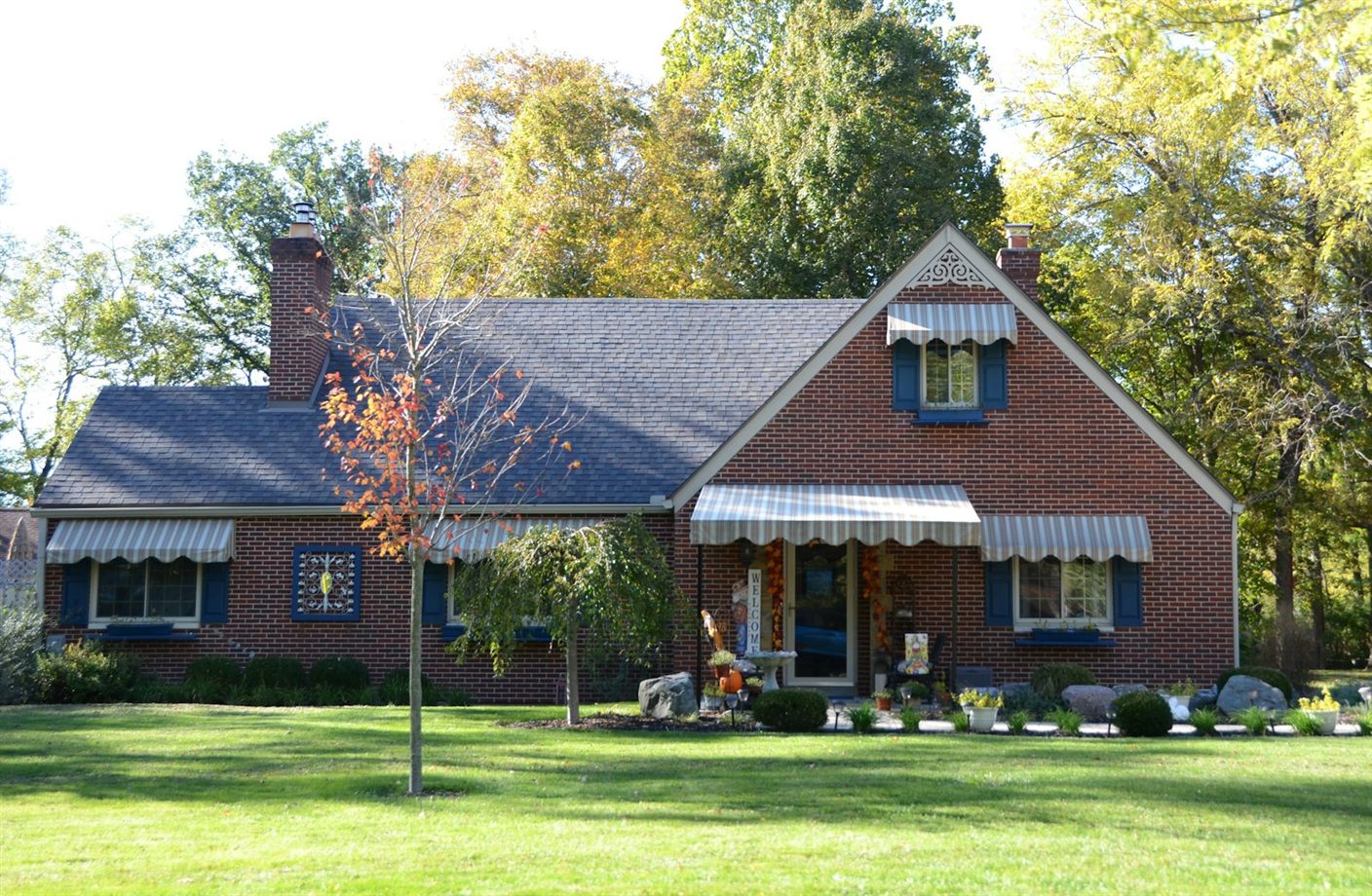 Well-kept brick home with a trimmed lawn