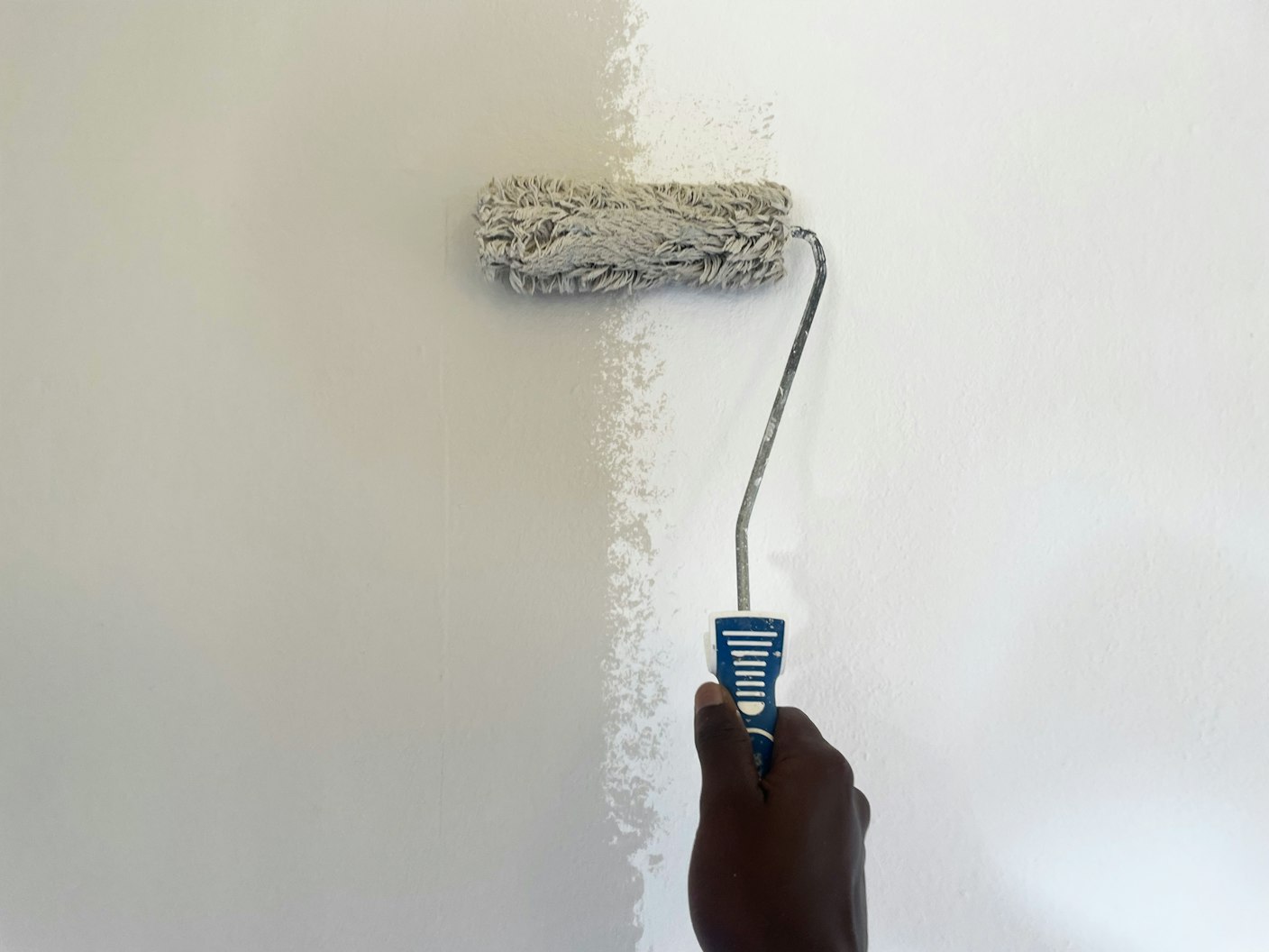 Interior wall being freshly painted with a roller